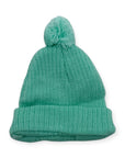 Green knit beanie with a pom-pom on a white background