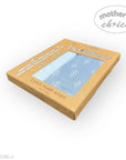 Box of bamboo muslin wraps with a blue towel on a white background