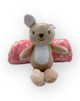 Plush deer toy with a pink pillow on a white background
