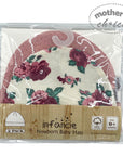 Packaged newborn baby hats with floral design and 'infancie' branding.