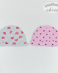 Two baby hats with heart patterns on a light gray background, branded 'Mother's Choice'.