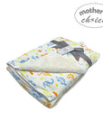 Baby blanket with dinosaur pattern and 'Mother's Choice' label on a white background