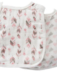 Baby bib with pink and gray leaf pattern on a white background