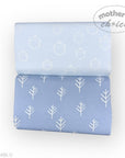 Two rolls of blue fabric with white patterns on a white background, featuring the brand 'Mother's Choice'.