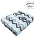 Folded blanket with zigzag pattern and 'Mother's Choice' label on a white background