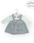 Baby outfit with gray dress and white shirt on a hanger against a white background, featuring 'mother's choice' branding.
