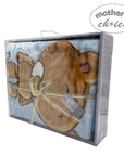 Plush teddy bear in a box with 'Mother's Choice' branding