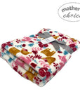 Floral patterned blanket with a gray ribbon on a white background, branded 'Mother's Choice'.