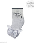 Gray baby socks with a bow and 'mother's choice' packaging on a white background