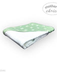 Folded green and white patterned towel with 'mother's choice' branding on a white background