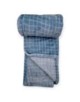Folded blue checkered blanket on a white background