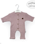 Pink baby romper with buttons on a hanger against a white background, featuring 'Mother's Choice' branding.