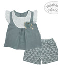 Children's outfit with top and shorts featuring floral patterns on a white background.