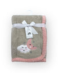 Baby blanket with cloud and moon design on a white background