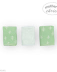 Three green fabric swaddles with white tree patterns on a white background, branded 'Mother's Choice'.