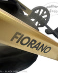 Close-up of a gold scooter frame with 'FIORANO' branding on a white background.