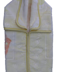 Folded baby blanket with circular patterns on a white background