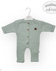 Green baby romper with brown buttons on a white background, featuring 'mother's choice' branding.