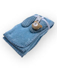 Folded blue towel with a teddy bear toy on a white background