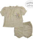 Beige baby outfit with embroidered design on a white background