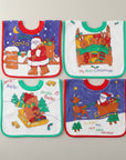 Four Christmas-themed baby bibs on a light gray background