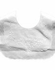 White baby bib with floral embroidery on a white background