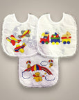 Three baby bibs with colorful airplane, train, and bear designs on a gray background
