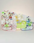 Set of colorful children's bibs with various designs on a white background