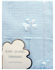 Blue baby shawl with a white bow and label on a white background