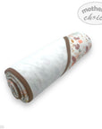 Rolled-up baby blanket with floral pattern on a white background, featuring 'Mother's Choice' branding.