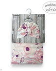 Floral-patterned turban hat and matching blanket with 'Mother's Choice' branding on a wooden background.