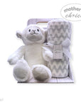 Baby gift set with white teddy bear and gray chevron blanket in a box, branded 'Mother's Choice'.