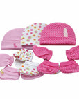 Set of pink baby hats and booties with floral patterns on a white background