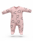 Pink baby onesie with black heart patterns on a white background