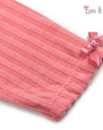 Pink pleated garment with a bow on a white background, featuring the brand 'Luna & Lily'.