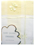 Yellow and white baby shawl with a bow on a white background