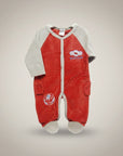 Red baby onesie with white accents on a beige background