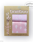 Packaging of bamboo waterproof change pad covers with pink designs on a white background.