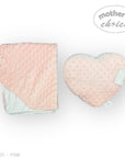 Pink textured blanket and heart-shaped pillow with 'mother's choice' branding on a white background.