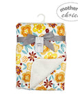 Floral-patterned baby blanket with a gray ribbon and 'mother's choice' tag on a white background