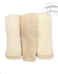 Three beige textured towels stacked on a white background with 'Mother's Choice' branding.