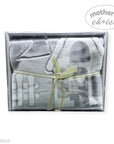 Gray baby blanket with a yellow ribbon in a clear box, branded 'Mother's Choice'.