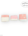 Three baby swaddles with pink and white design on a white background, branded 'Mother's Choice'.