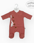 Red baby romper with buttons on a white background, featuring 'mother's choice' branding.