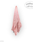 Pink towel hanging on a white wall with 'mother's choice' branding.