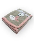 Gray and pink blanket with cloud designs on a white background