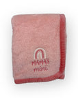 Pink baby blanket with 'MAMA'S mini' embroidery on a white background