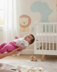 Stork And Baby white 3-piece baby girl set with pink ribbed pants and a unicorn print bodysuit.