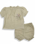 Stork And Baby beige muslin 2-piece set with embroidered bunnies and flowers on the top. Elastic waist shorts.