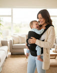 Stork And Baby black 6-way elegant baby carrier with adjustable positions for hands-free carrying.